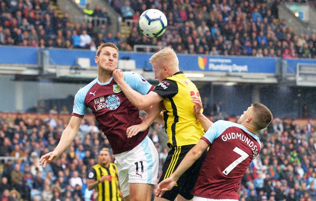 Burnley’s Chris Wood and Watford’s Will Hughes battle for the ball