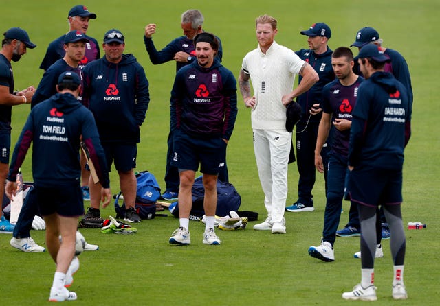 England captain Ben Stokes, fourth right, and his team warm up on the pitch 