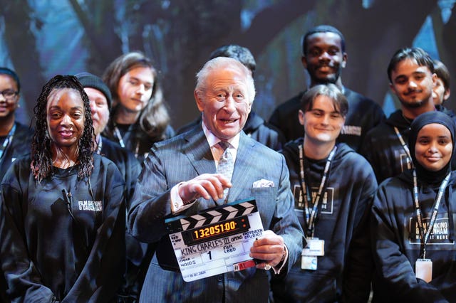 Charles holding a clapperboard