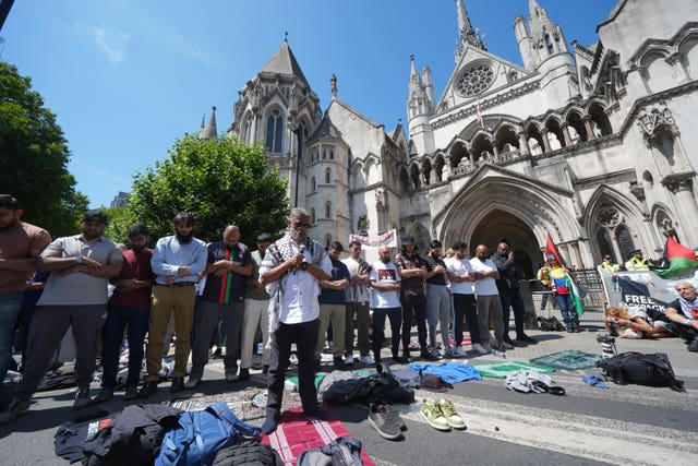 Palestine Action protesters outside the Royal Courts of Justice on The Strand, central London