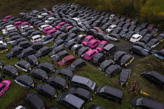 Hundreds of taxis are being stored in fields dotted around the edge of London due to the lack of customers (Victoria Jones/PA)