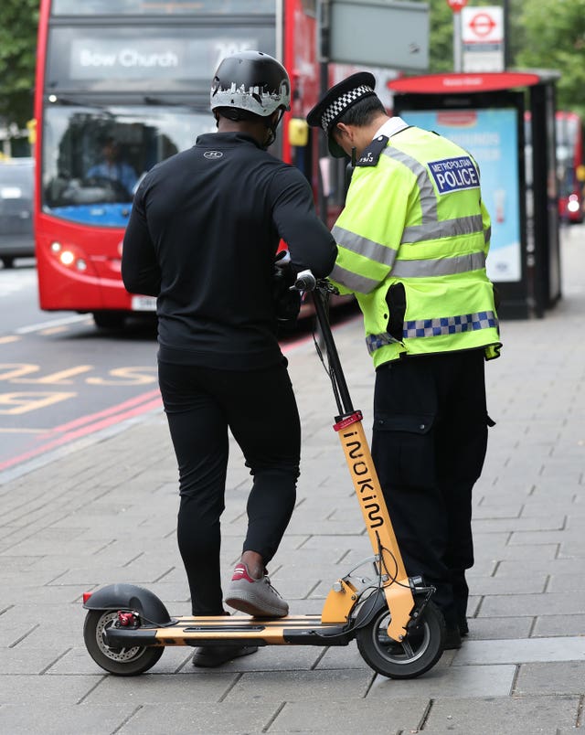 Metropolitan Police officers in Islington, north London issue a warning to an electric scooter rider (Yui Mok/PA)
