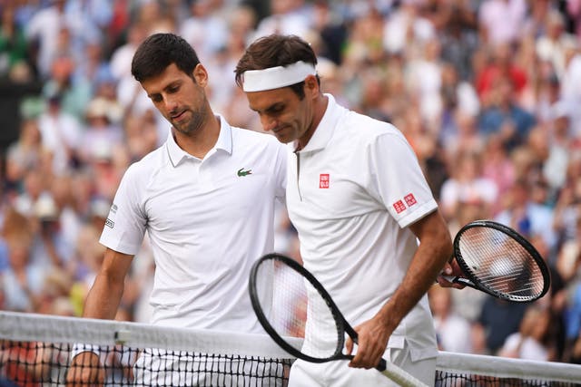 Djokovic , left, is congratulated by Roger Federer after the Wimbledon final