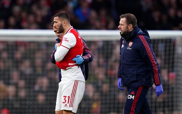 Sead Kolasinac, left, leaves the game with an injury to his right arm