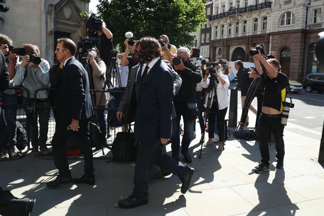 Actor Johnny Depp, centre, arriving at the High Court in London for a hearing in his libel case against the publishers of The Sun and its executive editor Dan Wootton