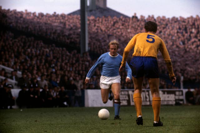 Francis Lee runs at Everton defender Brain Labone