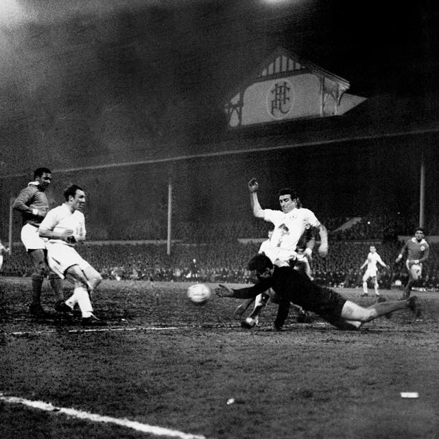 The Benfica goalkeeper dives at the feet of Spurs attackers Jimmy Greaves (left) and Bobby Smith in the European Cup semi-finals