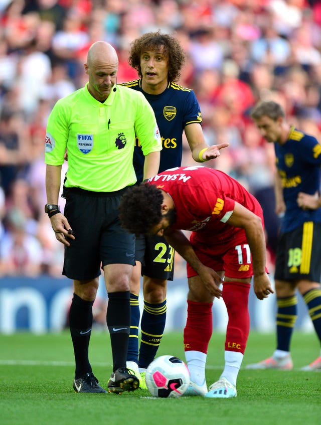 Mohamed Salah places the ball for his penalty as David Luiz, centre, protests to referee Anthony Taylor 