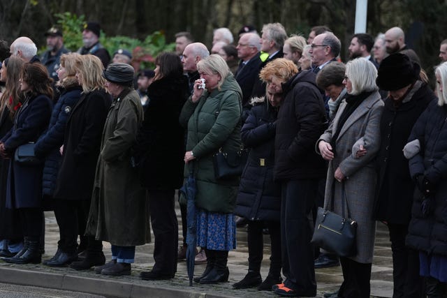People paying their respects along the route