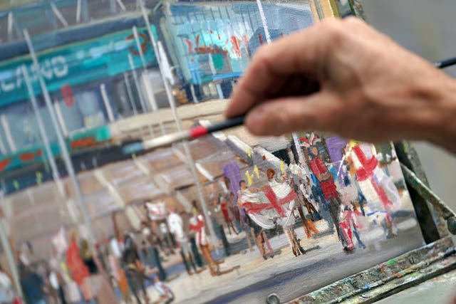 An artist paints a picture of Wembley Stadium ahead of the Euro 2020 final