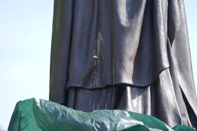 The contents of a thrown egg drip down the newly installed statue of Baroness Margaret Thatcher (Joe Giddens/PA)