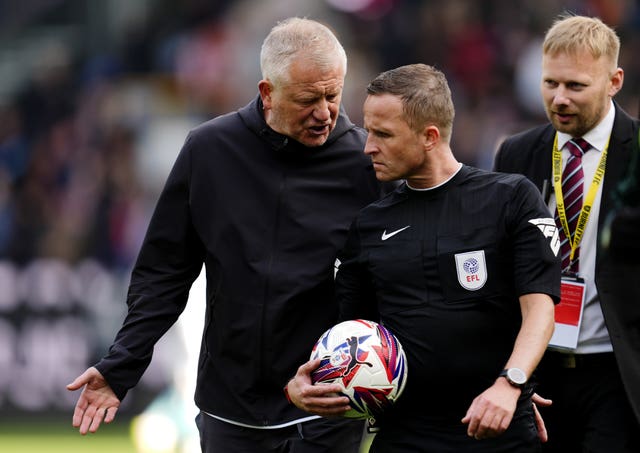 Sheffield United manager Chris Wilder, left, speaks to referee David Webb
