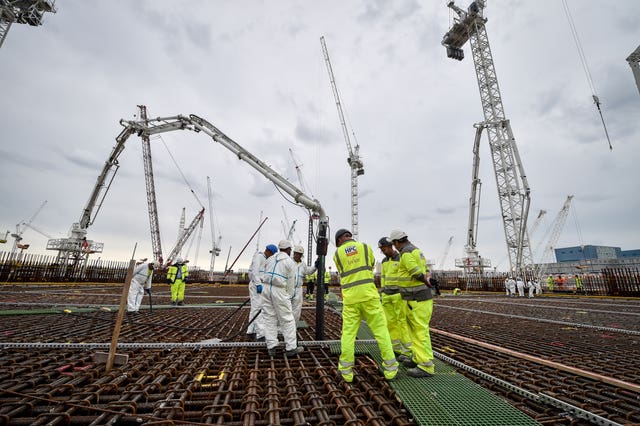 Construction workers stand on the base for the first reactor at Hinkley Point C power station near Bridgwater, Somerset