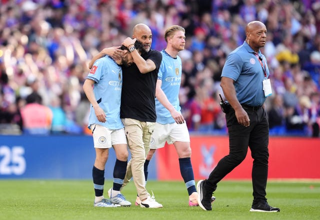 Manchester City boss Pep Guardiola comforts Bernardo Silva after losing the FA Cup final