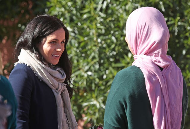 Meghan is greeted by girls from the boarding house