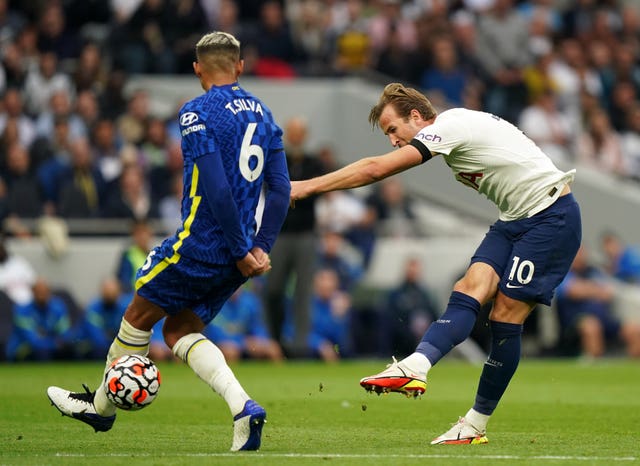 Harry Kane, right, takes a shot under pressure from Chelsea's Thiago Silva