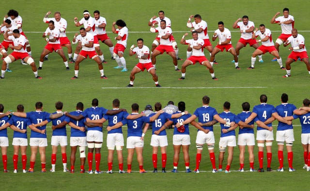 France look on as Tonga's players perform the Sipi Tau
