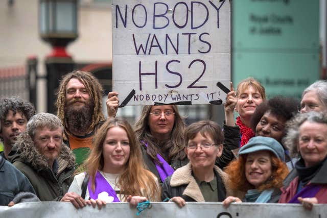 Protesters make their views known as Chris Grayling launched a High Court action to stop ‘unlawful protest’ by demonstrators opposed to HS2 running through a woodland area in west London (Victoria Jones/PA)