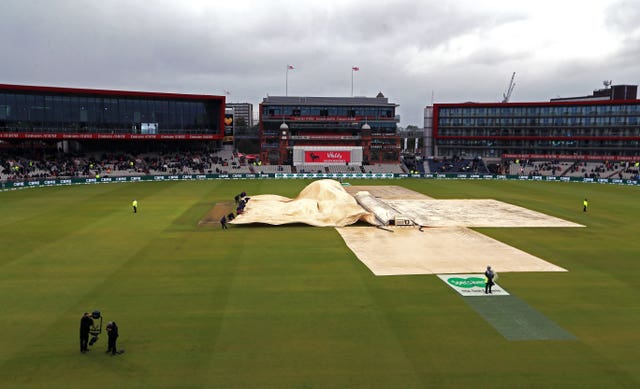 It was difficult to get the covers on on a blustery day at Old Trafford