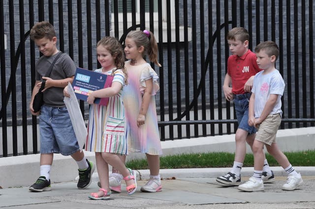 A group of children, including Etta Blythe (second left), walking on Downing Street