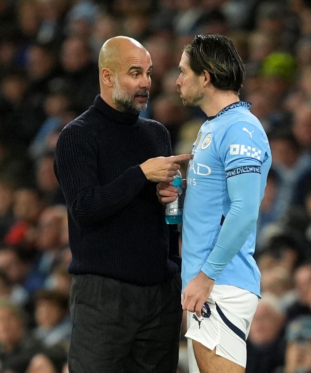 Pep Guardiola speaks to Jack Grealish on the touchline