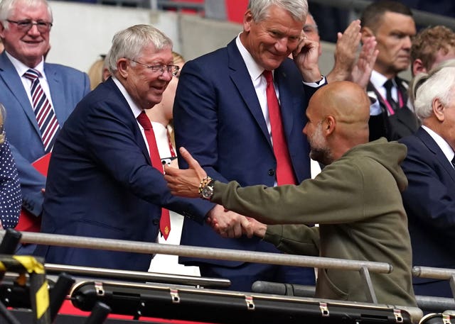 Sir Alex Ferguson, left, shakes hands with Pep Guardiola