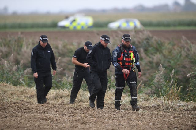 Police and forensics officers investigating the disappearance of Bernadette Walker