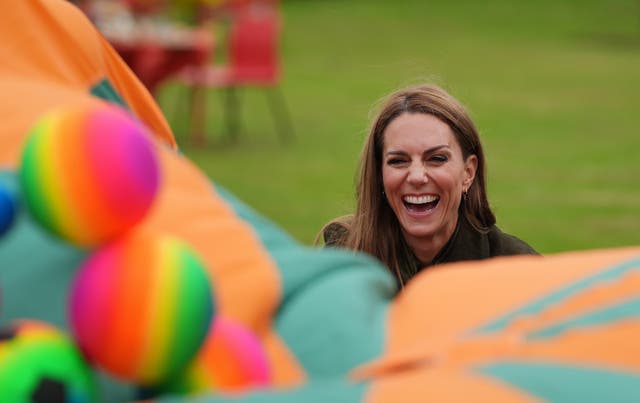 Kate playing a game as she met members of the Scouts’ Squirrels with Melania Trump in Frogmore Gardens in September