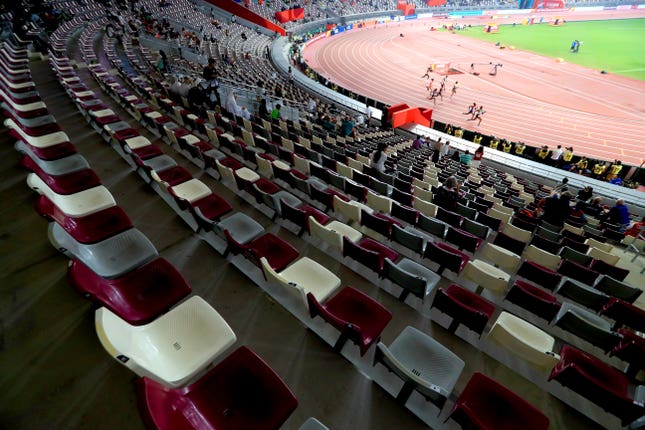 The Women’s 200 metres heats take place in front of banks of empty seats