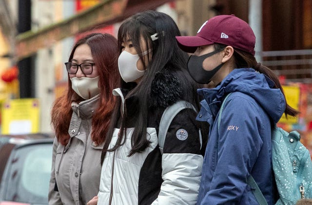 Members of the Chinese community in Manchester wearing face masks (Peter Byrne/PA)