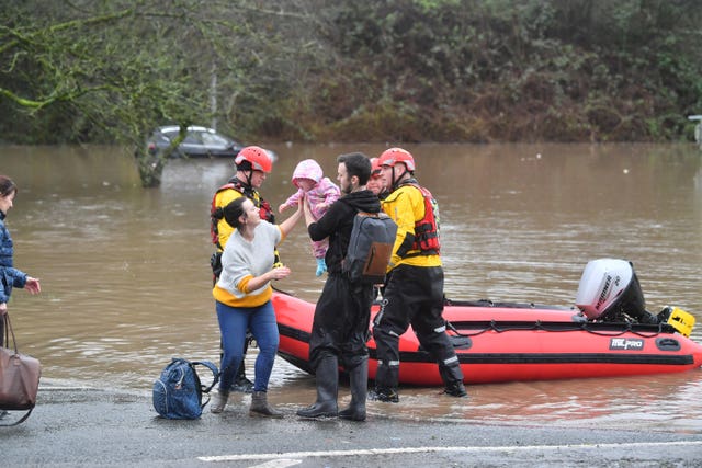 A family is taken to safety after flooding in Nantgarw 