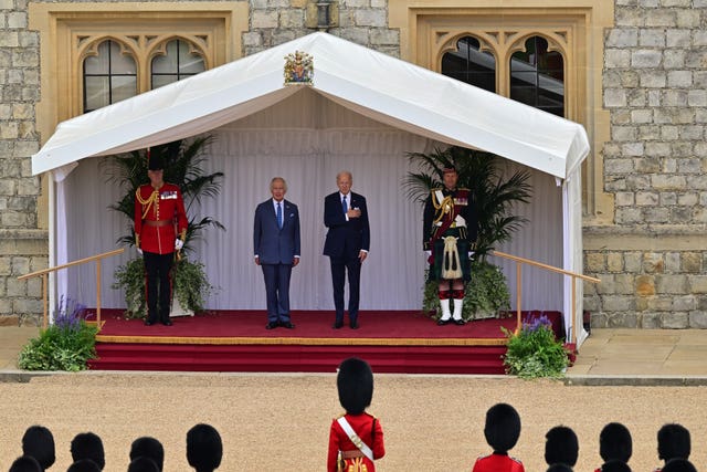 The King and Joe Biden listen to the US National Anthem played by the Band of the Welsh Guards