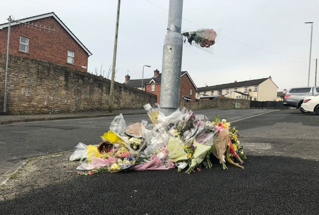 Flowers at the spot where Lyra McKee was killed in Creggan