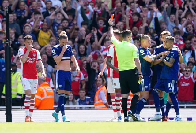 Referee Chris Kavanagh shows a red card to Luke Ayling