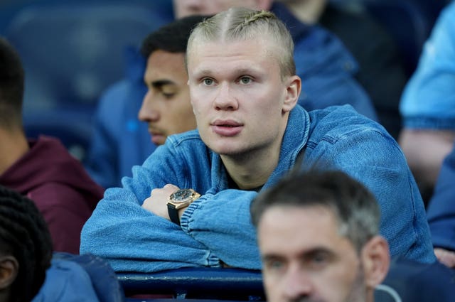 Erling Haaland sits in the crowd to watch a Manchester City game while out injured