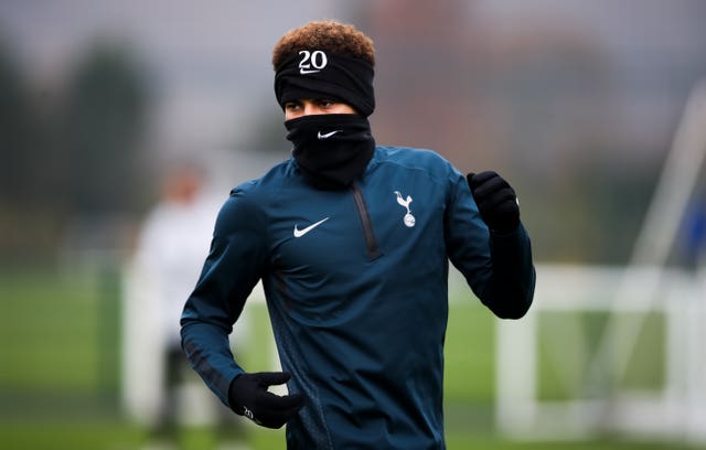 Dele Alli keeps warm in training