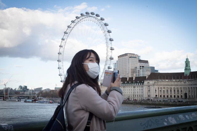 A woman takes precautions in central London