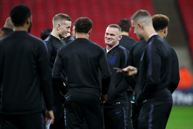 Rooney shares a pre-match joke with his team-mates