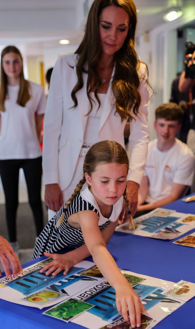 Princess Charlotte, and the Duchess of Cambridge take part in an interactive learning experience during a visit to SportsAid House at the 2022 Commonwealth Games the Birmingham 2022 Commonwealth Games