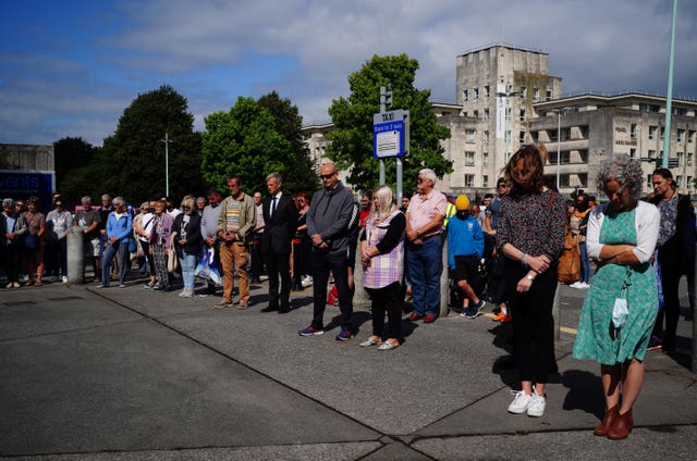 People take part in a minute’s silence outside Plymouth Guildhall in memory of the five people killed by Davison