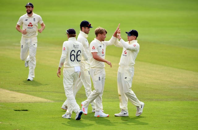 Sam Curran (second right) celebrates taking the wicket of Abid Ali