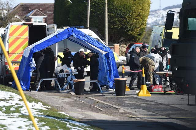 Police and army personnel suit up on Larkhill Road in Durrington, Salisbury (Ben Birchall/PA)