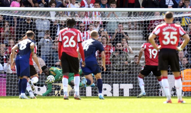 Manchester United goalkeeper Andre Onana saves Southampton striker Cameron Archer's penalty by diving to his right