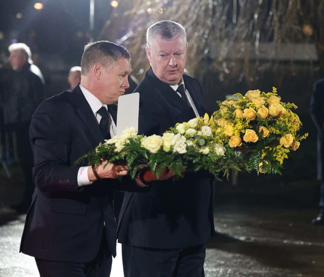 Wreaths being carried into the church in Dunboyne, Co Meath, before John Bruton's funeral