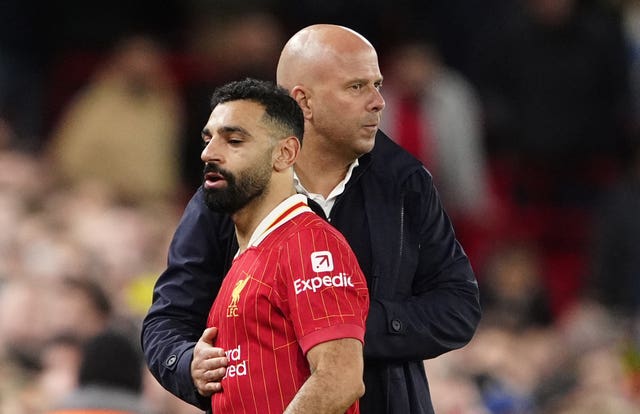 Arne Slot, right, embraces Mohamed Salah as the forward is substituted