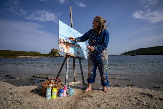 Seawater and sand become parts of Powell's work as she paints outside in all weathers (Ben Birchall/PA)