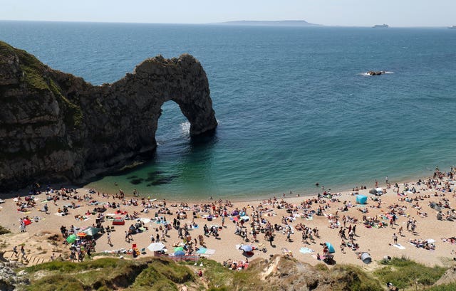 People fill the beach at Durdle Door, near Lulworth (Andrew Matthews/PA)