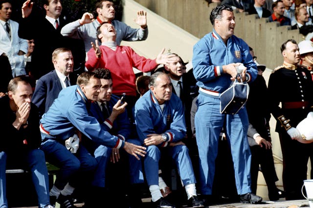 Jimmy Armfield, wearing red, celebrates behind Sir Alf Ramsey during the 1966 World Cup final