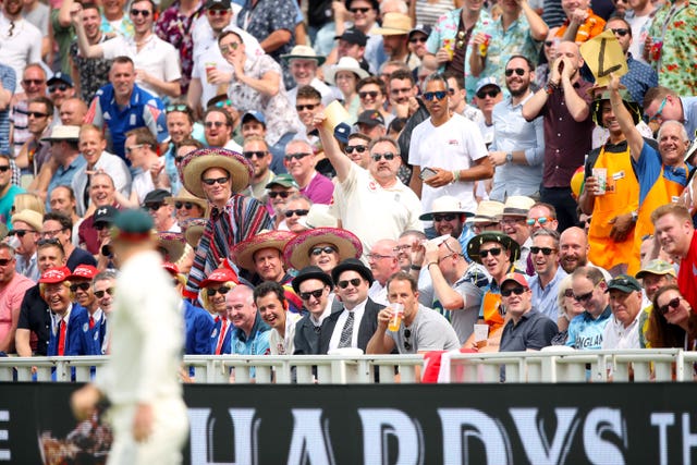 Spectators in the Hollies Stand offer David Warner some sandpaper during the opening Ashes Test