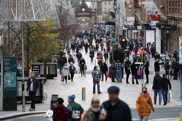 Members of the public walk along Buchanan Street in Glasgow